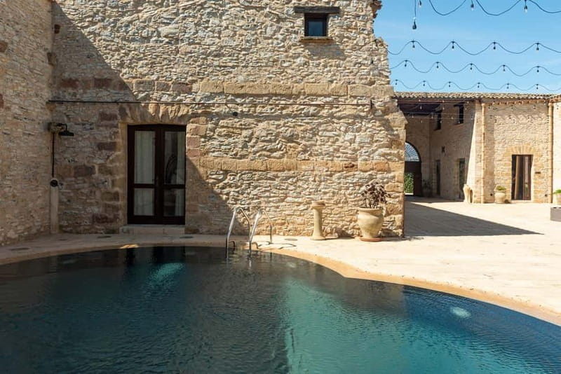 Nature and relaxation by the pool at Baglio Passofondo Estates - The included welcome drink sets the tone